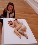Single woman looking at cuddling museum work